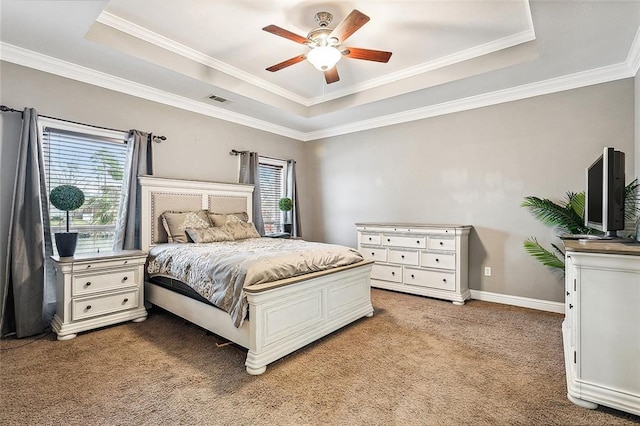 carpeted bedroom featuring ceiling fan, a raised ceiling, and crown molding