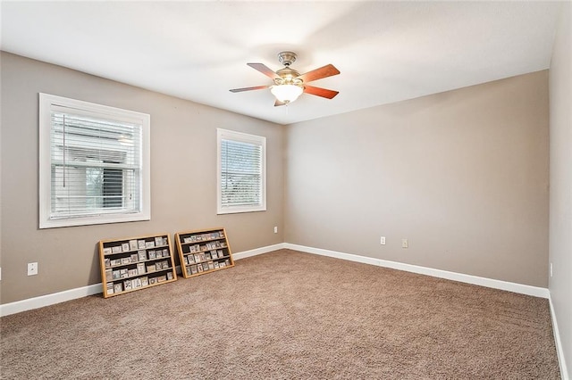 empty room with carpet flooring and ceiling fan