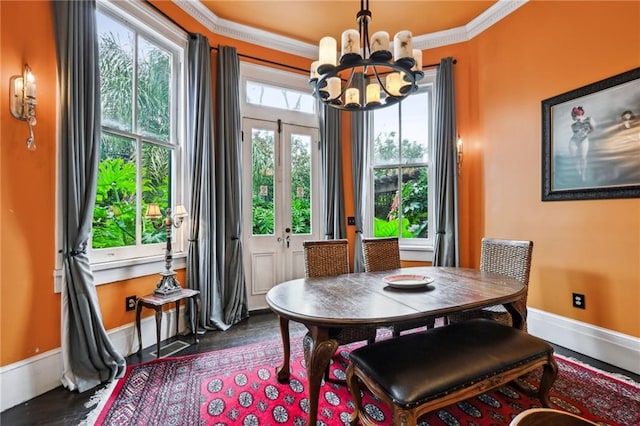 dining space featuring ornamental molding, french doors, and an inviting chandelier