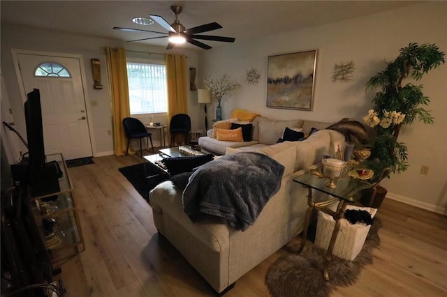 living room featuring light wood-type flooring and ceiling fan