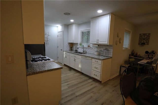 kitchen with light wood-type flooring, sink, dishwasher, range, and white cabinetry