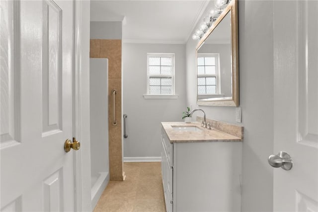 bathroom with vanity, tile patterned floors, crown molding, and a shower