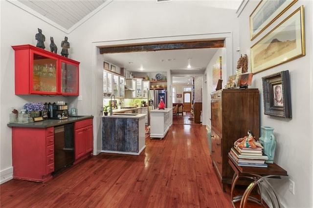 bar with appliances with stainless steel finishes, dark wood-type flooring, and lofted ceiling