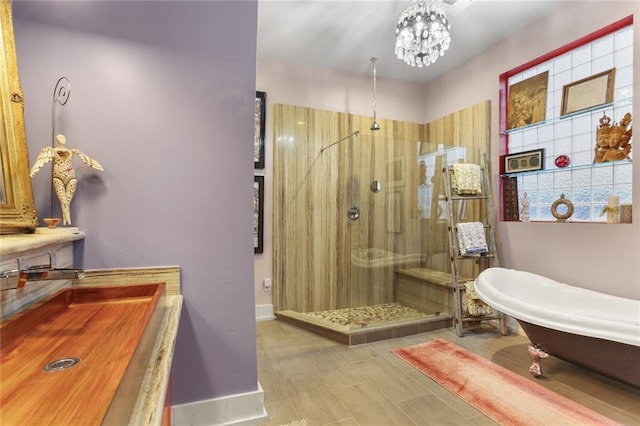 bathroom with vanity, a chandelier, and shower with separate bathtub