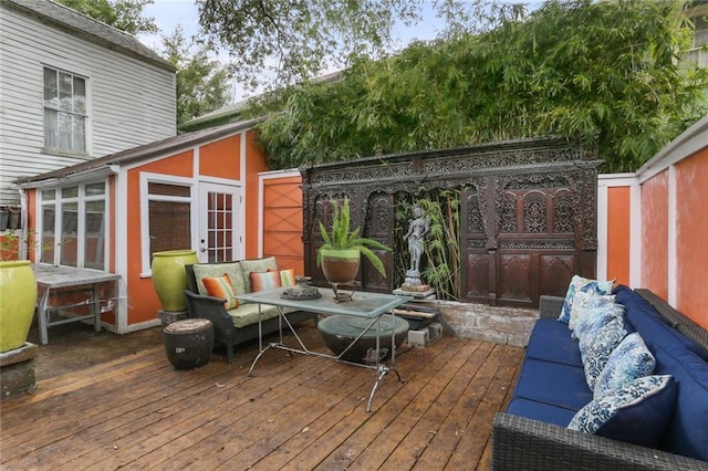 wooden deck featuring outdoor lounge area and french doors