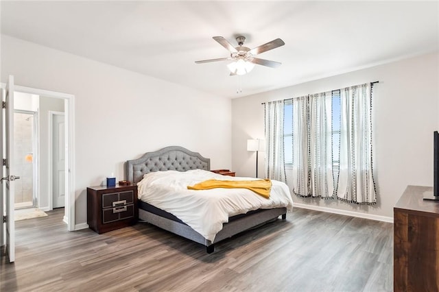 bedroom featuring connected bathroom, ceiling fan, and wood-type flooring