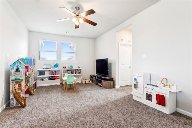 recreation room with carpet flooring and ceiling fan