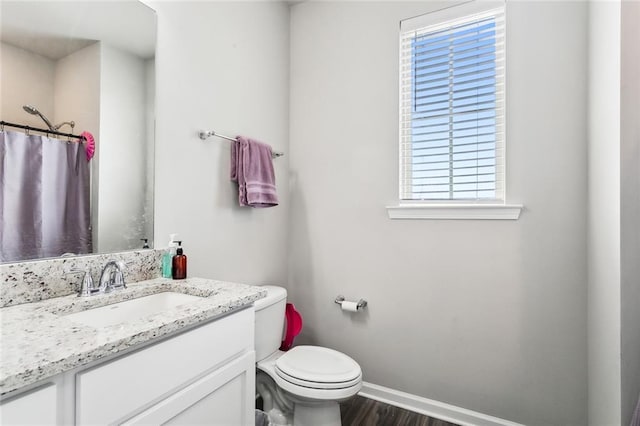 bathroom with vanity, hardwood / wood-style flooring, and toilet