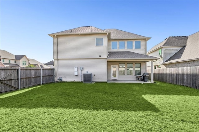 back of property featuring cooling unit, a yard, and a patio