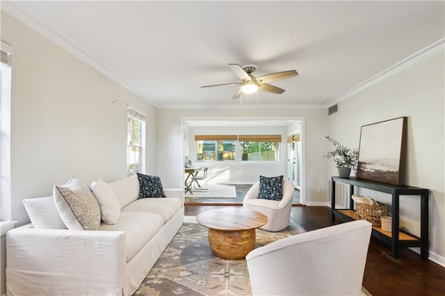 living room with dark hardwood / wood-style floors, ceiling fan, and crown molding