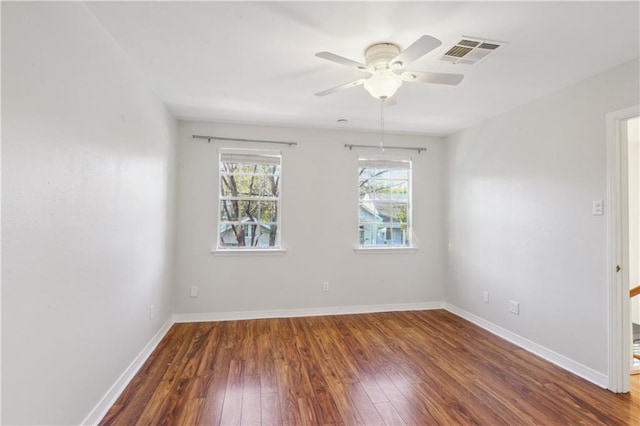 unfurnished room with dark hardwood / wood-style floors and ceiling fan