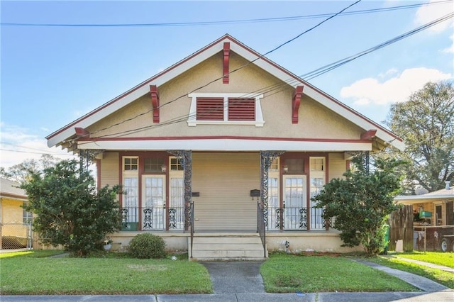 bungalow with a porch and a front yard