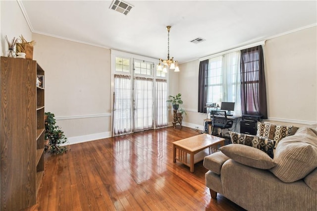 living room with a chandelier, ornamental molding, and wood-type flooring