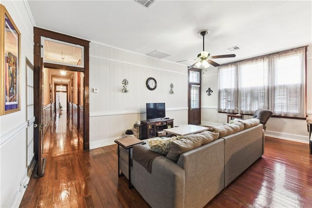 living room featuring ceiling fan, dark wood-type flooring, and ornamental molding