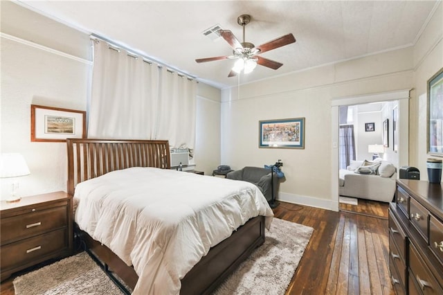 bedroom with dark wood-type flooring, ceiling fan, and ornamental molding