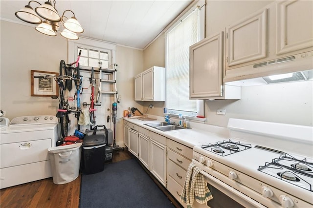 kitchen with washing machine and clothes dryer, white range with gas cooktop, a wealth of natural light, and sink