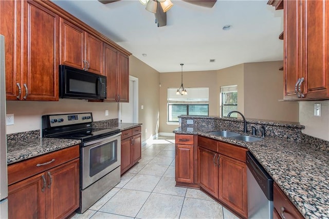 kitchen featuring sink, dark stone countertops, and stainless steel appliances