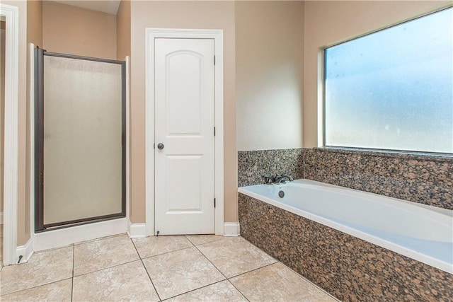 bathroom with tile patterned floors and plus walk in shower