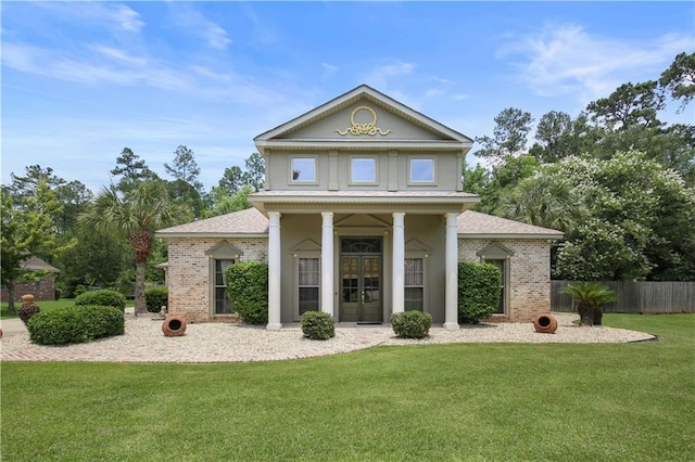 neoclassical home with french doors and a front lawn