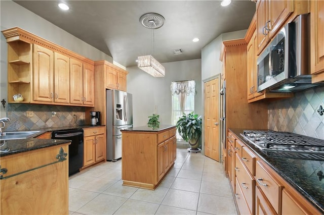 kitchen with decorative backsplash, a kitchen island, sink, and stainless steel appliances