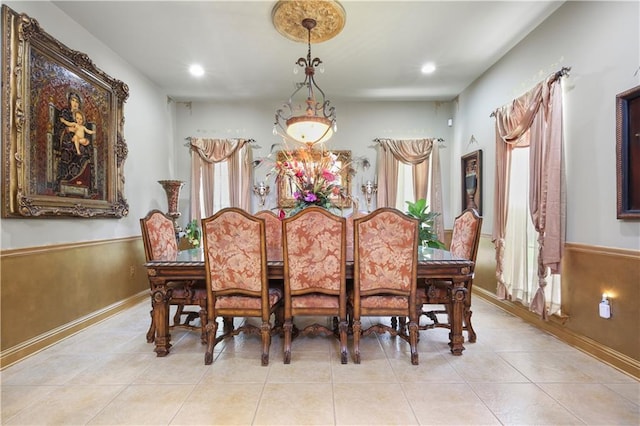 tiled dining area featuring wooden walls and plenty of natural light