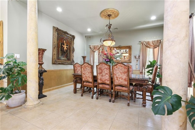 dining space featuring light tile patterned floors and decorative columns