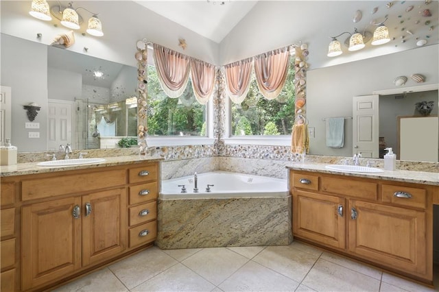 bathroom featuring tile patterned flooring, vanity, vaulted ceiling, and shower with separate bathtub