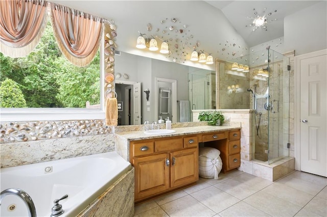 bathroom with tile patterned floors, vanity, separate shower and tub, and vaulted ceiling