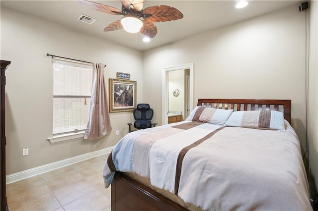 tiled bedroom featuring ceiling fan and ensuite bath