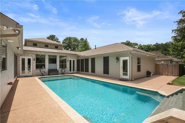 view of swimming pool with a patio area and french doors