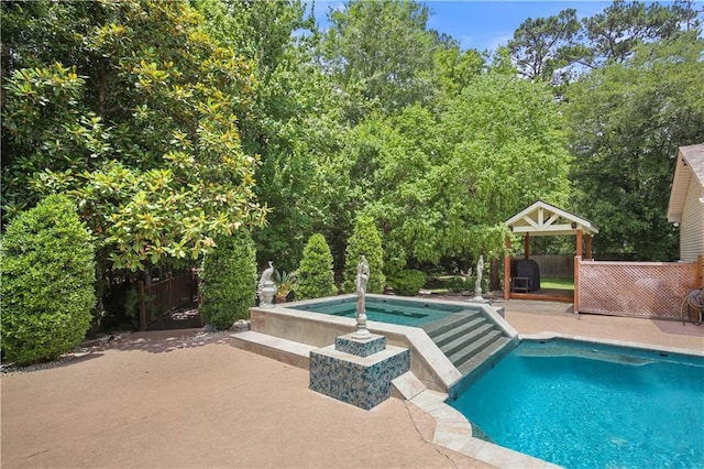 view of swimming pool with a patio area and an in ground hot tub