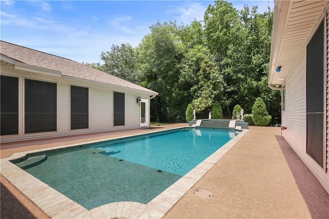 view of swimming pool featuring a jacuzzi and a patio