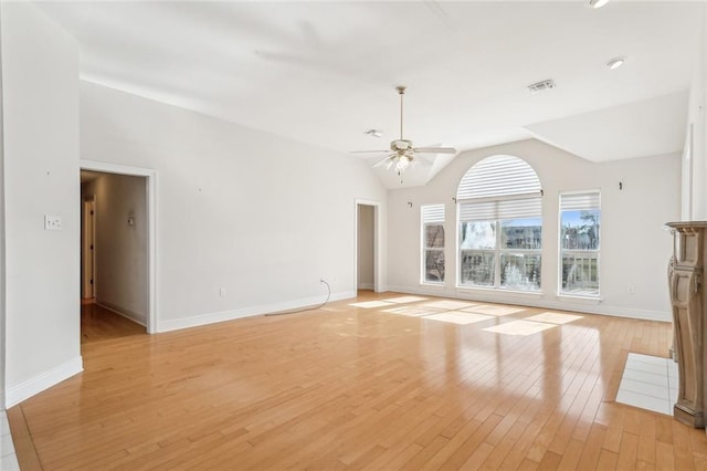 unfurnished living room with ceiling fan, vaulted ceiling, and light wood-type flooring