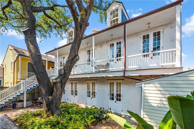 back of property featuring a balcony