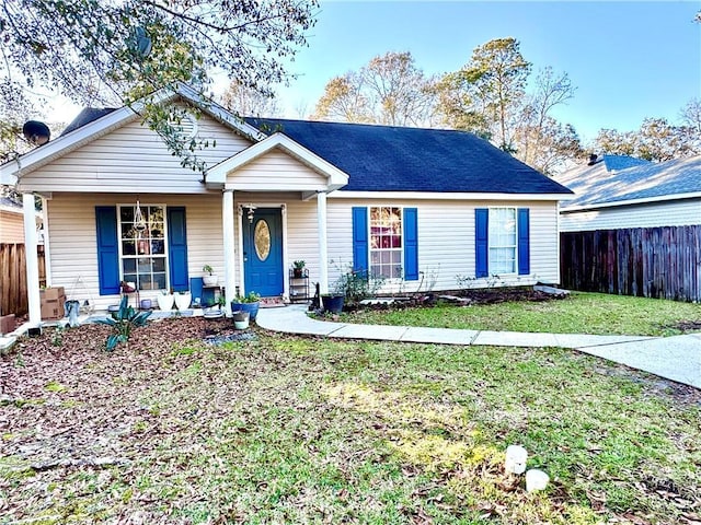 ranch-style house with a porch and a front lawn