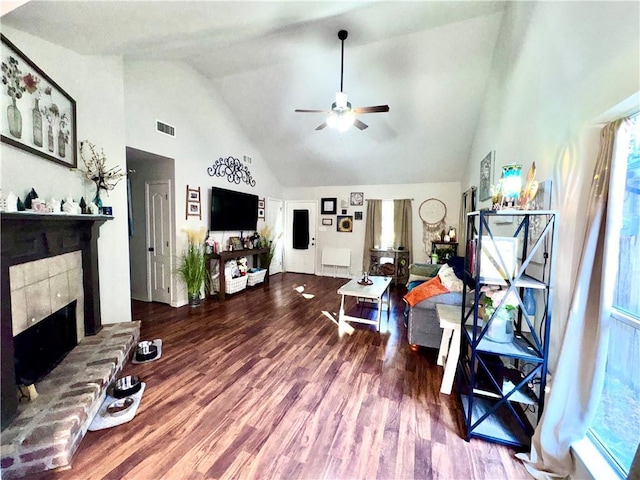 living room featuring hardwood / wood-style floors, high vaulted ceiling, and ceiling fan