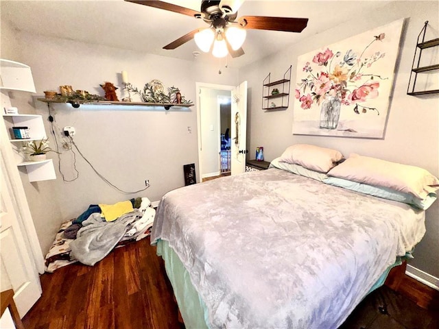 bedroom with ceiling fan and dark hardwood / wood-style flooring