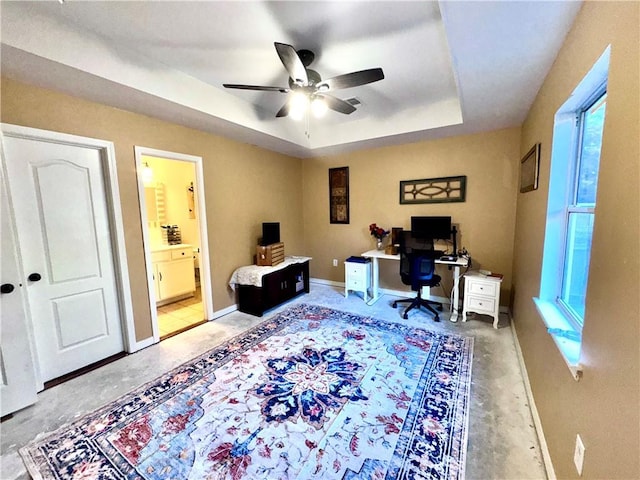 office featuring ceiling fan and a raised ceiling