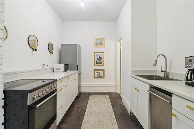 kitchen with white cabinets, appliances with stainless steel finishes, and sink