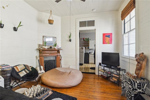 living room featuring ceiling fan and dark hardwood / wood-style flooring