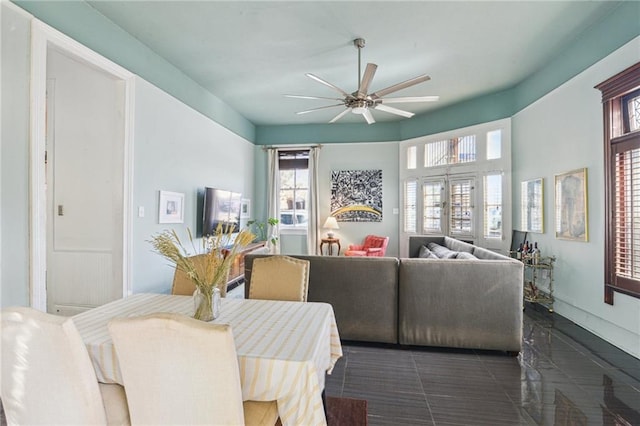 dining room featuring dark tile patterned floors and ceiling fan