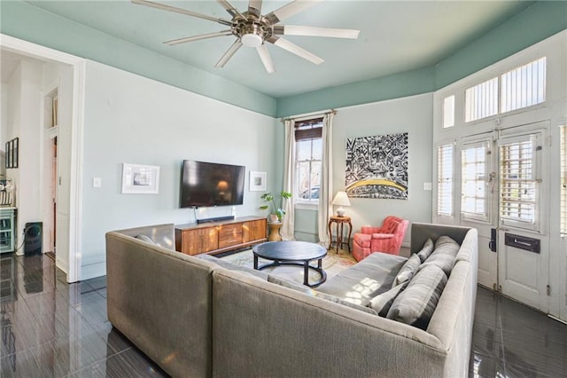 living room featuring ceiling fan and a healthy amount of sunlight