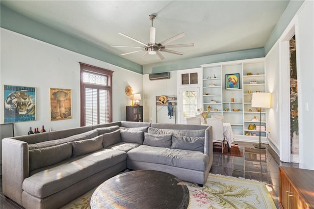 living room with ceiling fan and a wall mounted AC