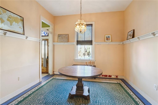 unfurnished dining area featuring a chandelier