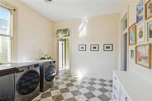 laundry area featuring cabinets and washing machine and dryer