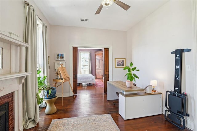 interior space with a fireplace, dark wood-type flooring, and plenty of natural light