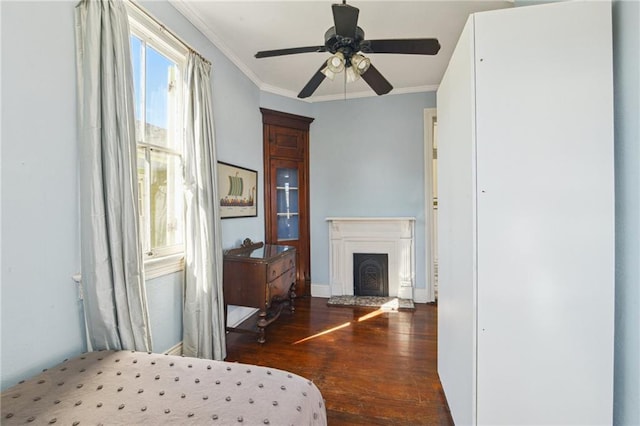 bedroom featuring ceiling fan, dark hardwood / wood-style floors, and ornamental molding