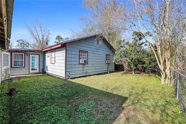 view of home's exterior with cooling unit and a yard