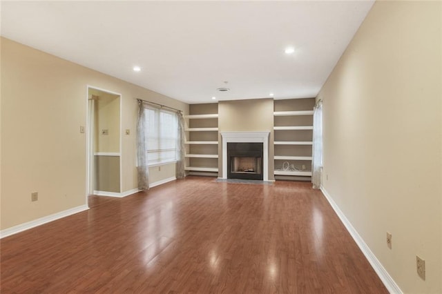 unfurnished living room featuring wood-type flooring