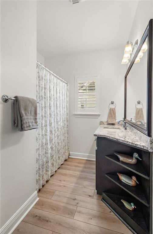 bathroom with wood-type flooring and vanity